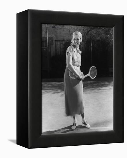 Smiling Woman Playing Tennis-null-Framed Stretched Canvas