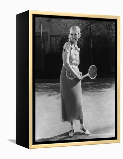 Smiling Woman Playing Tennis-null-Framed Stretched Canvas