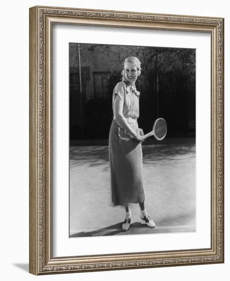 Smiling Woman Playing Tennis-null-Framed Photo