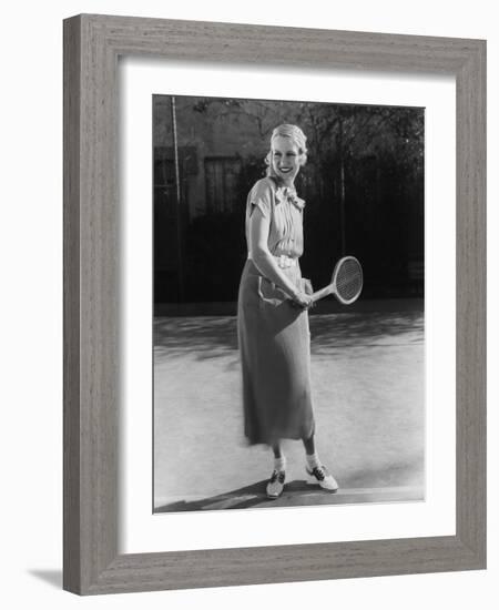 Smiling Woman Playing Tennis-null-Framed Photo