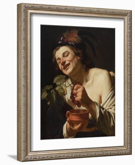 Smiling Young Man Squeezing Grapes, 1622 (Oil on Canvas)-Gerrit van Honthorst-Framed Giclee Print