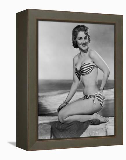 Smiling Young Woman Perches on a Stone Wall in a Striped Bikini-Charles Woof-Framed Premier Image Canvas