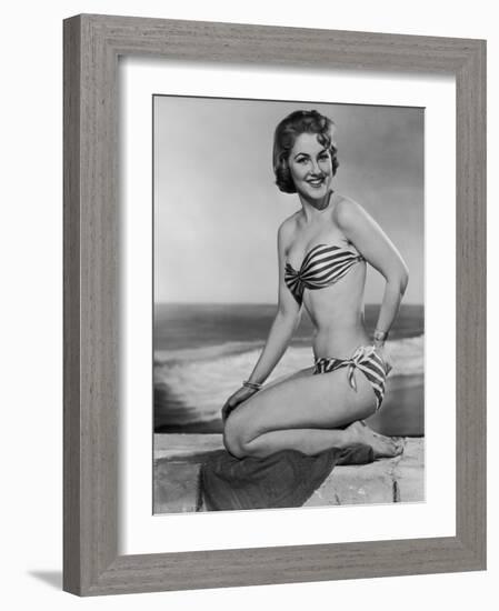Smiling Young Woman Perches on a Stone Wall in a Striped Bikini-Charles Woof-Framed Photographic Print