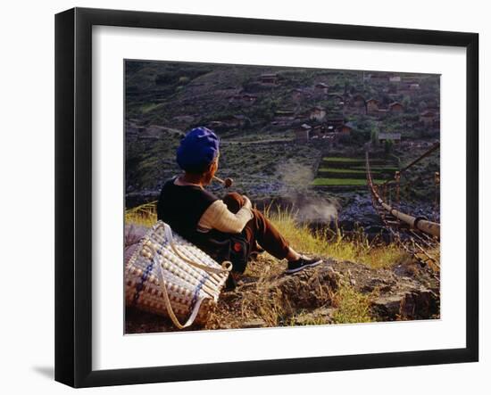 Smoking Her Pipe, a Naxi Woman Rests after Crossing a Precarious Pipe Bridge High Above the Yangtse-Amar Grover-Framed Photographic Print