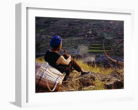 Smoking Her Pipe, a Naxi Woman Rests after Crossing a Precarious Pipe Bridge High Above the Yangtse-Amar Grover-Framed Photographic Print