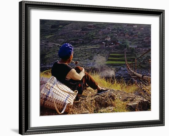 Smoking Her Pipe, a Naxi Woman Rests after Crossing a Precarious Pipe Bridge High Above the Yangtse-Amar Grover-Framed Photographic Print