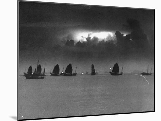 Smugglers' Junks Sailing in Dying Light of Dusk-Jack Birns-Mounted Photographic Print
