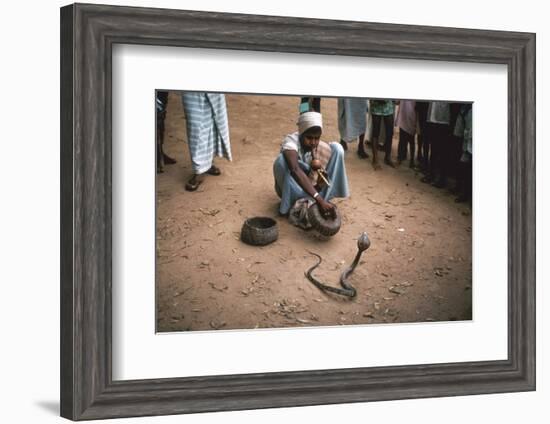 Snake charmer with cobra, in Sri Lanka. Artist: Unknown-Unknown-Framed Photographic Print