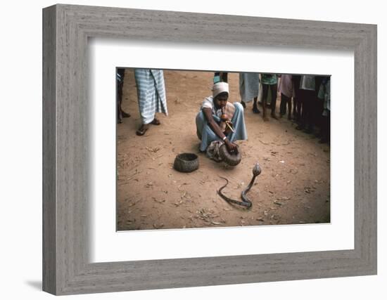 Snake charmer with cobra, in Sri Lanka. Artist: Unknown-Unknown-Framed Photographic Print