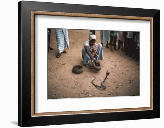 Snake charmer with cobra, in Sri Lanka. Artist: Unknown-Unknown-Framed Photographic Print