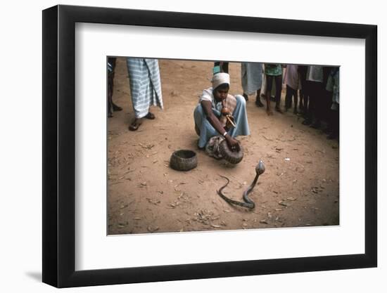 Snake charmer with cobra, in Sri Lanka. Artist: Unknown-Unknown-Framed Photographic Print