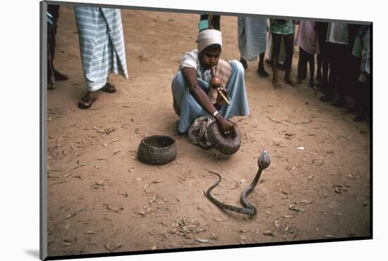 Snake charmer with cobra, in Sri Lanka. Artist: Unknown-Unknown-Mounted Photographic Print