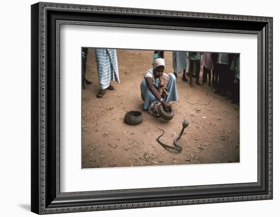 Snake charmer with cobra, in Sri Lanka. Artist: Unknown-Unknown-Framed Photographic Print