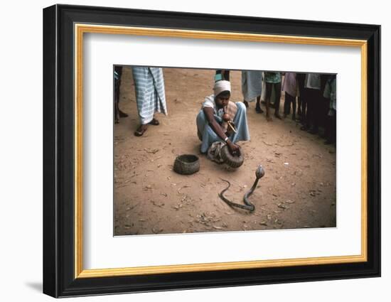 Snake charmer with cobra, in Sri Lanka. Artist: Unknown-Unknown-Framed Photographic Print