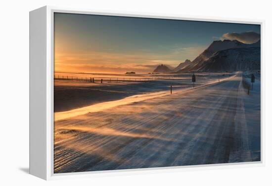 Snow Blows across an Icelandic Road at Sunrise with Mountains Looming in the Distance-Alex Saberi-Framed Premier Image Canvas