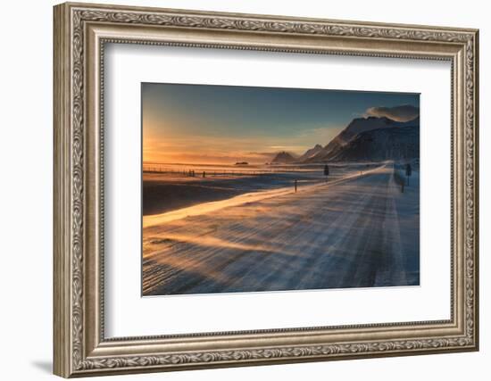 Snow Blows across an Icelandic Road at Sunrise with Mountains Looming in the Distance-Alex Saberi-Framed Photographic Print