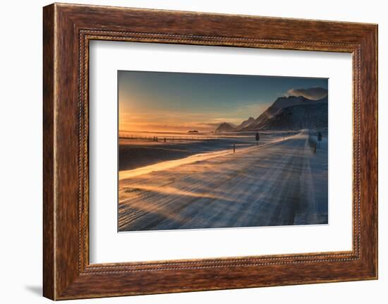 Snow Blows across an Icelandic Road at Sunrise with Mountains Looming in the Distance-Alex Saberi-Framed Photographic Print