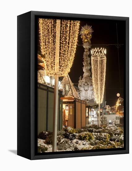Snow-Covered Flowers, Christmas Decorations and Baroque Trinity Column at Christmas Market, Austria-Richard Nebesky-Framed Premier Image Canvas