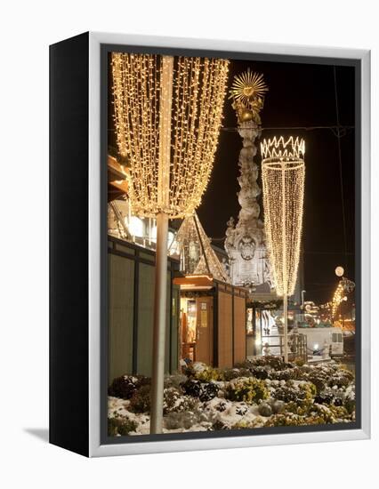 Snow-Covered Flowers, Christmas Decorations and Baroque Trinity Column at Christmas Market, Austria-Richard Nebesky-Framed Premier Image Canvas