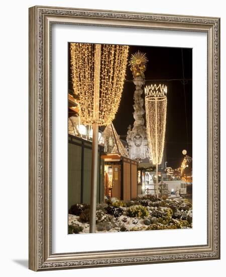 Snow-Covered Flowers, Christmas Decorations and Baroque Trinity Column at Christmas Market, Austria-Richard Nebesky-Framed Photographic Print