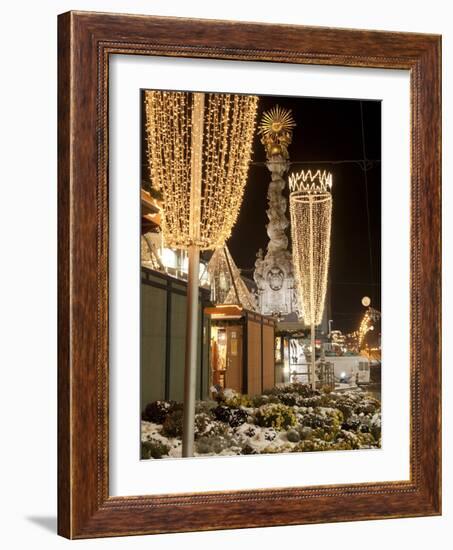 Snow-Covered Flowers, Christmas Decorations and Baroque Trinity Column at Christmas Market, Austria-Richard Nebesky-Framed Photographic Print