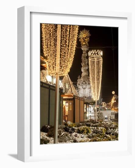 Snow-Covered Flowers, Christmas Decorations and Baroque Trinity Column at Christmas Market, Austria-Richard Nebesky-Framed Photographic Print