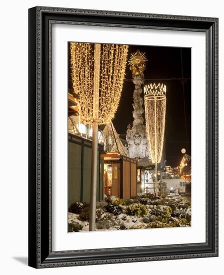 Snow-Covered Flowers, Christmas Decorations and Baroque Trinity Column at Christmas Market, Austria-Richard Nebesky-Framed Photographic Print