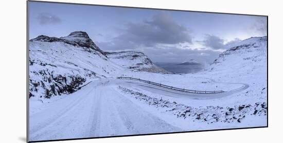 Snow covered mountain road on the Island of Streymoy, Faroe Islands, Denmark, Europe. Winter (March-Adam Burton-Mounted Photographic Print