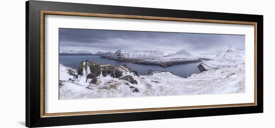 Snow covered mountain scenery above Funningsfjørdur on the island of Eysturoy, Faroe Islands, Denma-Adam Burton-Framed Photographic Print