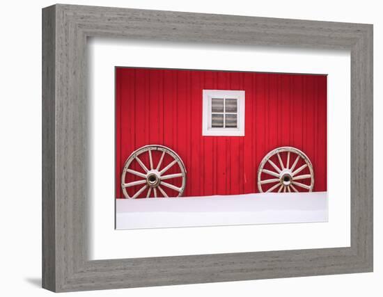 Snow-covered wagon wheels against red barn near town of Banff, Canadian Rockies, Alberta, Canada-Stuart Westmorland-Framed Photographic Print