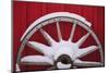 Snow-covered wagon wheels against red barn near town of Banff, Canadian Rockies, Alberta, Canada-Stuart Westmorland-Mounted Photographic Print