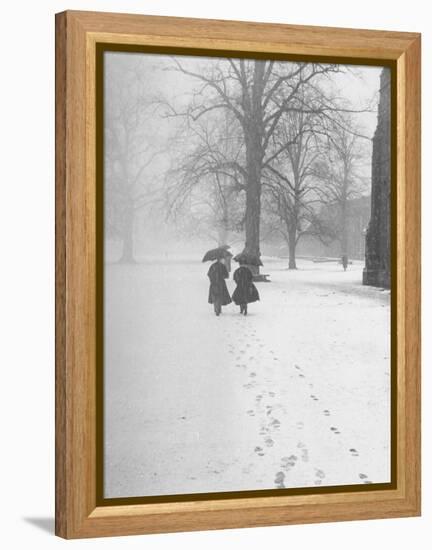 Snow Falling While People Take a Stroll Across Campus of Winchester College-Cornell Capa-Framed Premier Image Canvas