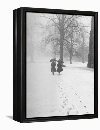 Snow Falling While People Take a Stroll Across Campus of Winchester College-Cornell Capa-Framed Premier Image Canvas