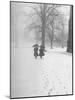 Snow Falling While People Take a Stroll Across Campus of Winchester College-Cornell Capa-Mounted Photographic Print