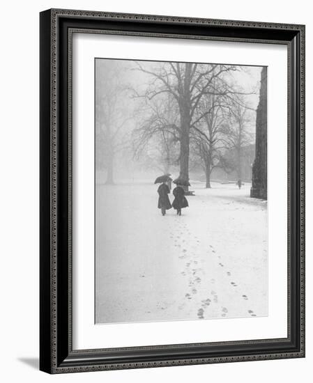 Snow Falling While People Take a Stroll Across Campus of Winchester College-Cornell Capa-Framed Photographic Print