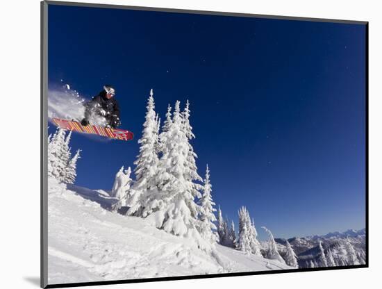 Snowboarding Action at Whitefish Mountain Resort in Whitefish, Montana, USA-Chuck Haney-Mounted Photographic Print