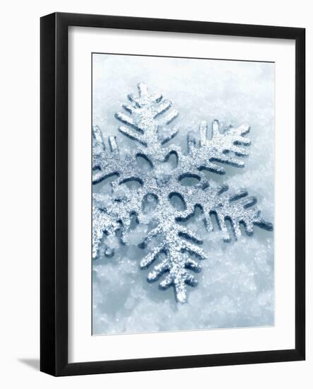 Snowflake Shaped Christmas Ornament Lying in the Snow-null-Framed Photographic Print