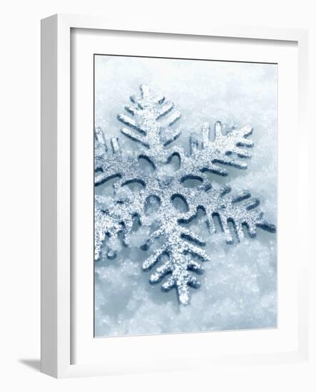 Snowflake Shaped Christmas Ornament Lying in the Snow-null-Framed Photographic Print