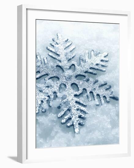 Snowflake Shaped Christmas Ornament Lying in the Snow-null-Framed Photographic Print