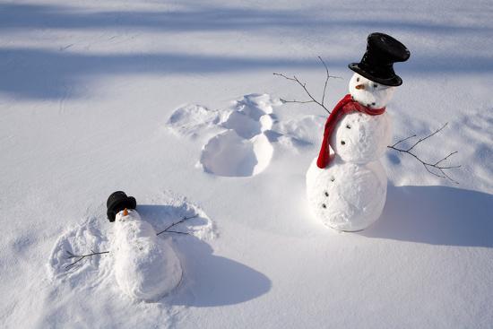 Snowmen in Forest Making Snow Angel Imprint in Snow in Late Afternoon Sunlight Alaska Winter' Photographic Print - Design Pics Inc | Art.com