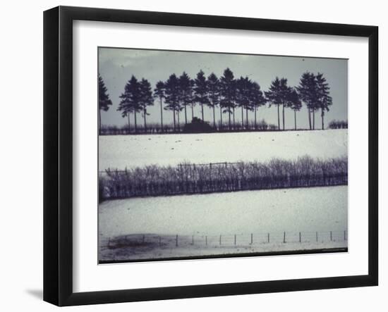 Snowy Landscape Frames Single American Tank Moving Along Distant Road During Battle of the Bulge-George Silk-Framed Photographic Print