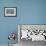 Snowy owl standing behind dried plant in snow, Canada-Markus Varesvuo-Framed Photographic Print displayed on a wall