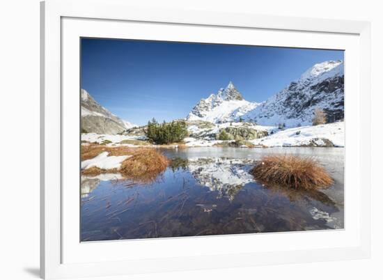 Snowy peaks are reflected in the alpine lake partially frozen, Lejets Crap Alv (Crap Alv Laiets), C-Roberto Moiola-Framed Photographic Print