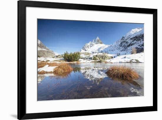 Snowy peaks are reflected in the alpine lake partially frozen, Lejets Crap Alv (Crap Alv Laiets), C-Roberto Moiola-Framed Photographic Print