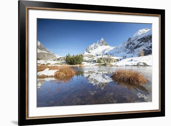 Snowy peaks are reflected in the alpine lake partially frozen, Lejets Crap Alv (Crap Alv Laiets), C-Roberto Moiola-Framed Photographic Print