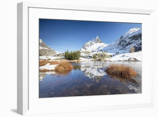 Snowy peaks are reflected in the alpine lake partially frozen, Lejets Crap Alv (Crap Alv Laiets), C-Roberto Moiola-Framed Photographic Print