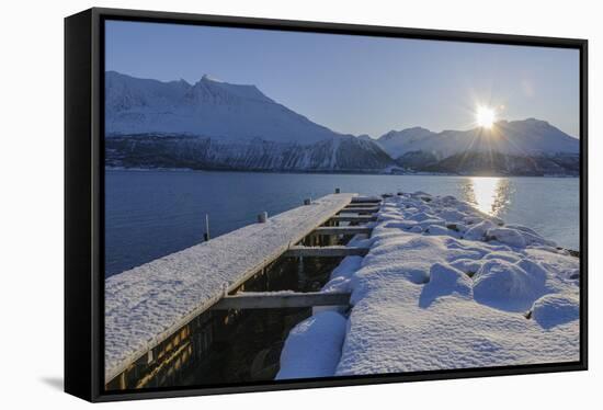 Snowy pier with sun, Buvik, Kvaloy, Troms, Norway-Raimund Linke-Framed Stretched Canvas