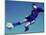 Soccer Player Jumping in Mid Air to Kick a Soccer Ball-null-Mounted Photographic Print