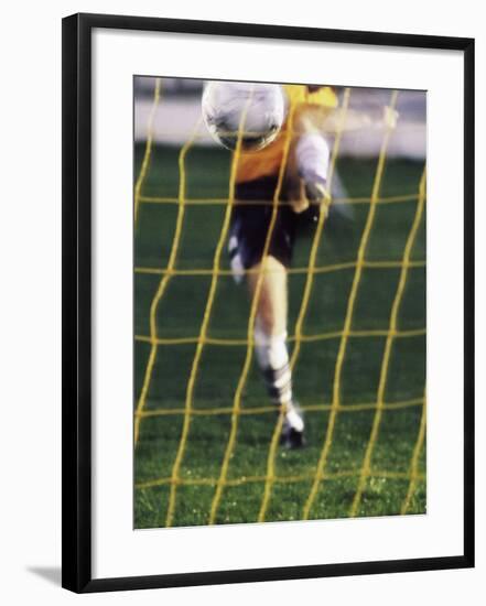 Soccer Player Kicking a Soccer Ball-null-Framed Photographic Print