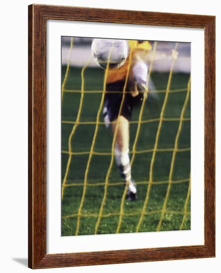 Soccer Player Kicking a Soccer Ball-null-Framed Photographic Print